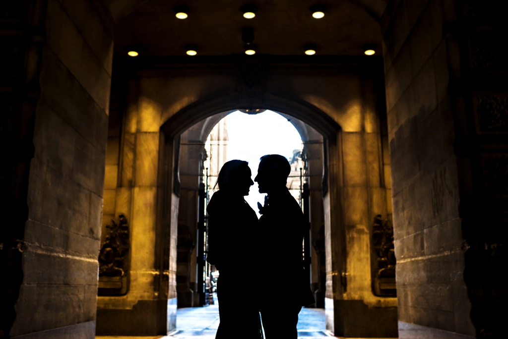 A silhouette of a wedding couple in the arches of City Hall in Philadelphia.